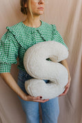 boucle letter cushion S teddy pillow by bettys home held by woman in green shirt baby gift idea