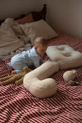 little baby boy in bed next to boucle letter cushion B and J teddy pillow by bettys home