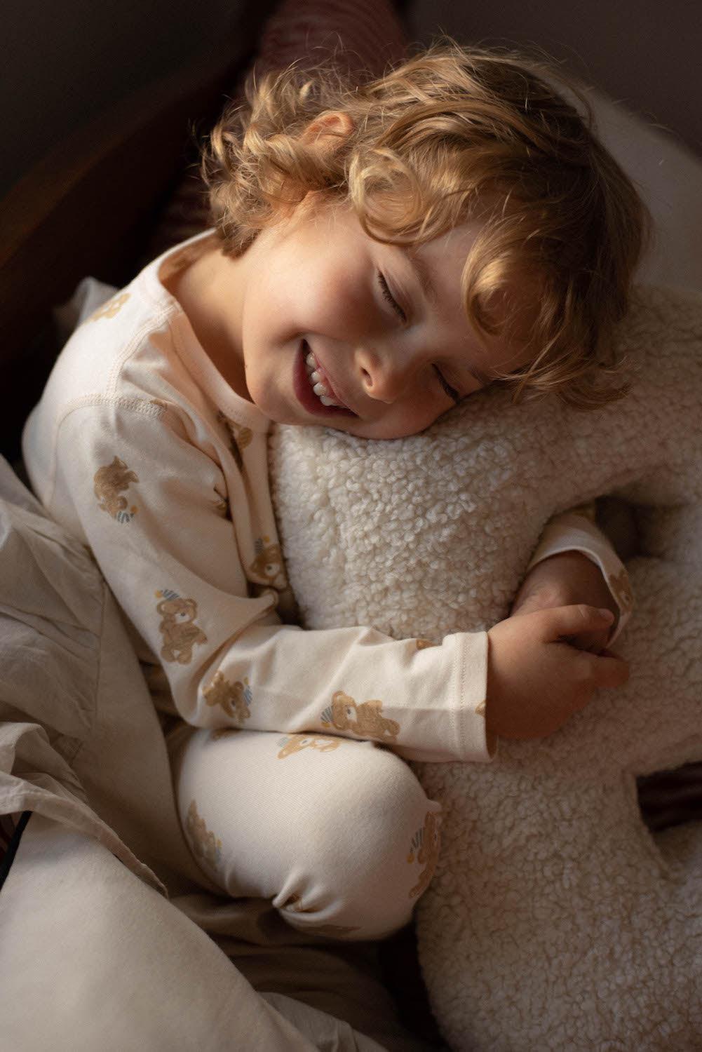 little boy hugging Boucle Letter Cushion by Bettys Home