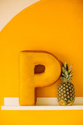 Velvet Letter cushion P in yellow on shelf. Xmas gift ideas for coworkers. Baby boy shower decorations. Best holiday gift