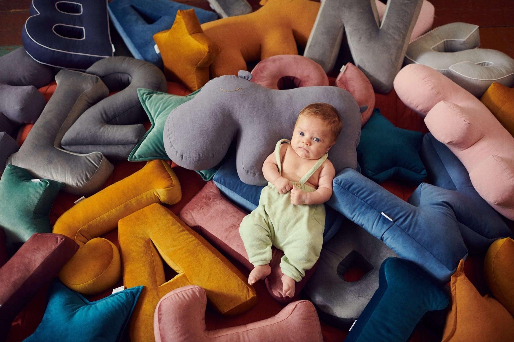 many pillows letter shaped by bettys home around little few months old child